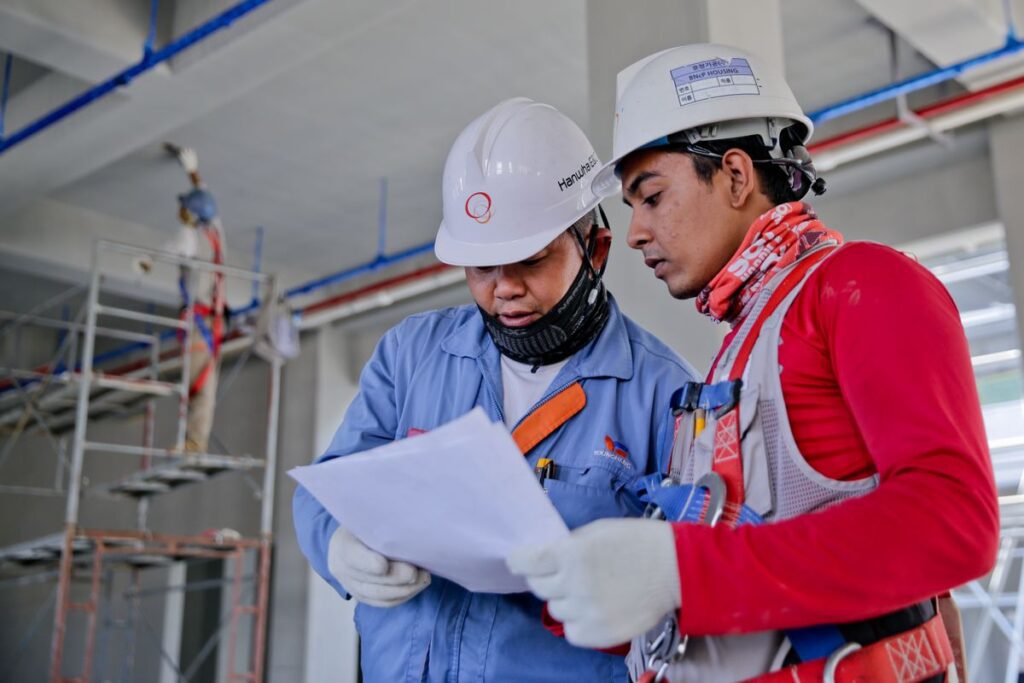 Fractional Cfo For Construction Companies Reviewing Project Finances On A Job Site